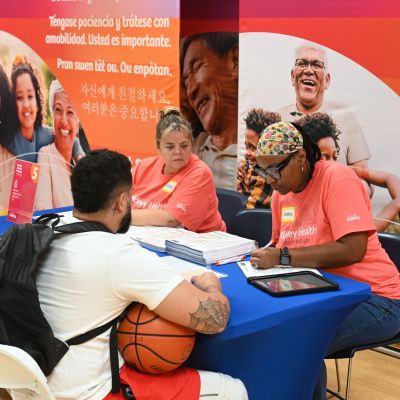 Man with a basketball at DaVita Community Health Experience Table